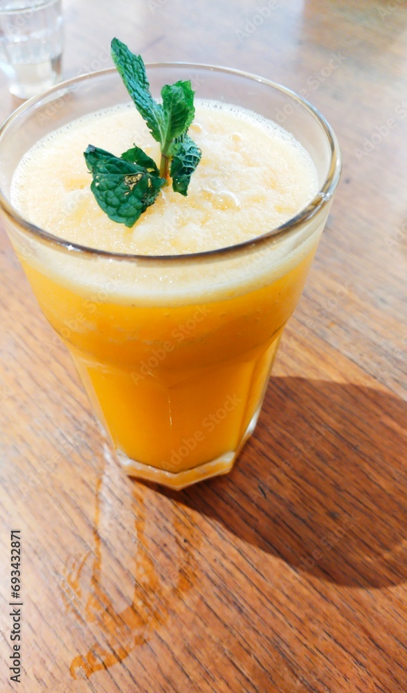 glass of fresh sun kist orange juice on wooden table glass of fresh sun kist orange juice on wooden table