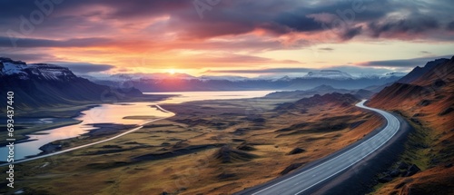 icelandic majesty: aerial panorama of scenic road, mountains, and coast at sunset