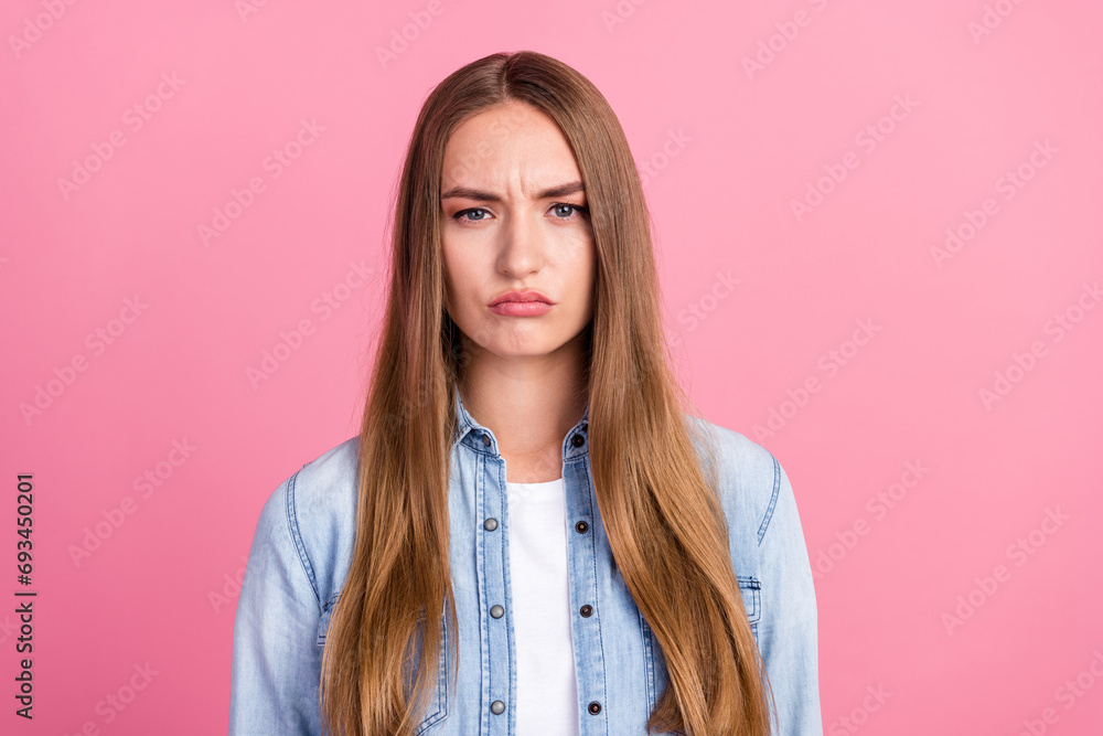Photo portrait of attractive young woman sad moody facial expression dressed stylish denim clothes isolated on pink color background Photo portrait of attractive young woman sad moody facial expression dressed stylish denim clothes isolated on pink color background