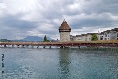 View of the Chapel Bridge and the Wasserturm (water tower) on river Reuss in historic city of Lucerne, Switzerland