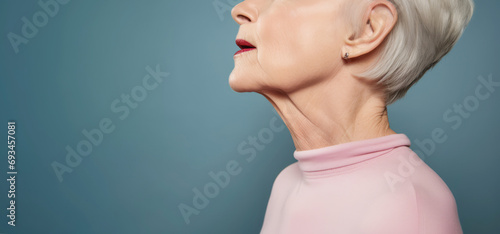 mature individual undergoes a thyroid check as part of a comprehensive health examination, addressing potential concerns such as hyperthyroidism or tumors. photo
