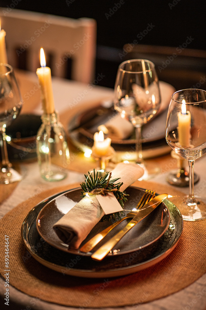winter holidays, dinner party and celebration concept - close up of scandinavian christmas table serving with burning candles at home at night - obrazy, fototapety, plakaty 