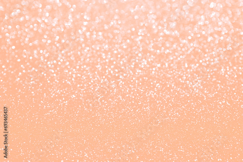 Peach fuzz sparkling glitter bokeh background