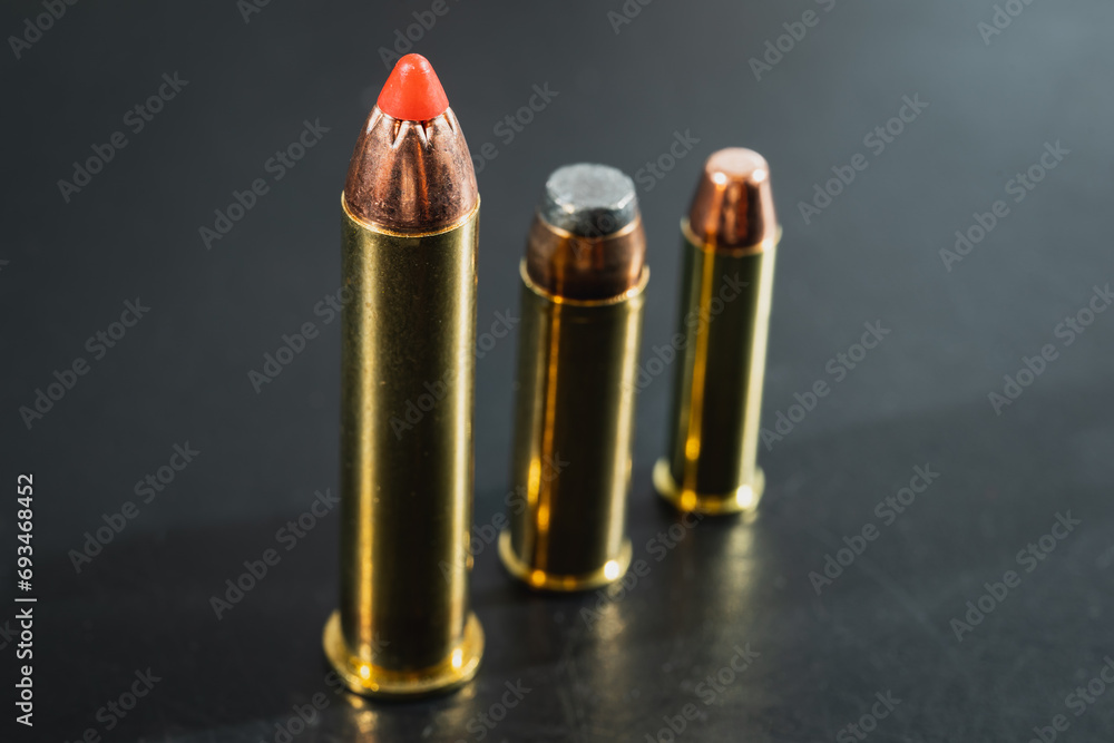 Macro photo, magnum class cartridges for revolvers and pistols, 45-70, 44 magnum, 357 magnum. Macro photo, magnum class cartridges for revolvers and pistols, 45-70, 44 magnum, 357 magnum.