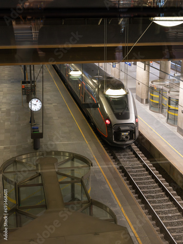 Photography Train making a scheduled stop to pick up travellers.