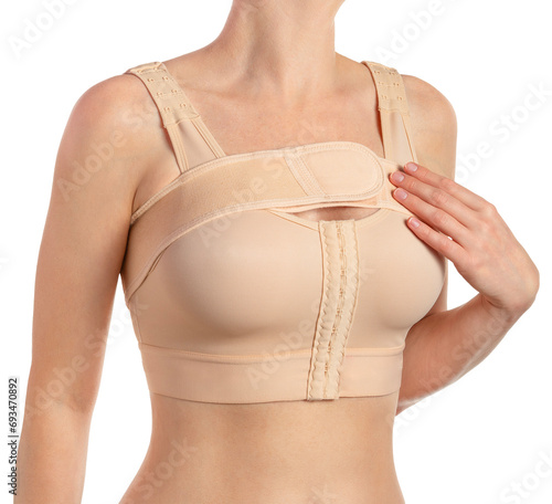 Female wearing compressing bra with a stipe after breast augmentation