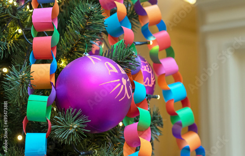 Garland-chain made of colored paper on Christmas tree. Christmas and New Year's decor.