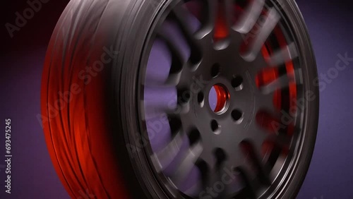 stylish car titanium wheels of black color eighteenth radius in red light in a dark room photo