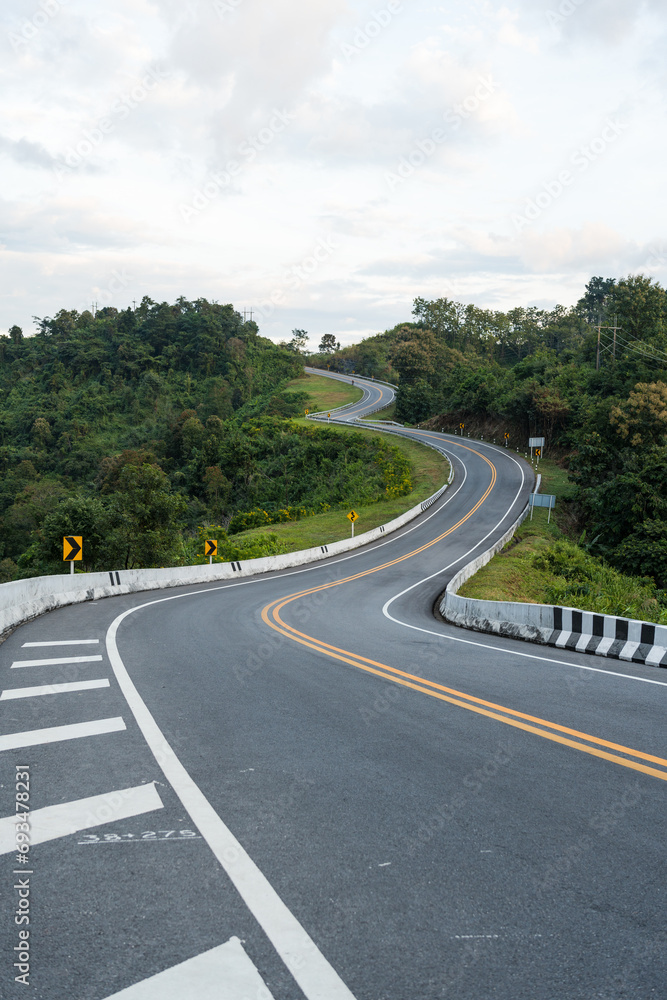 Beautiful curved road look like number 3 on the high mountain in Nan province, Thailand. An iconic tourist attraction place on the way to Bo Kluea district, Nan, Thailand.