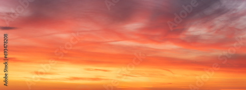 Wide-format, red sunset or sunrise, sky with a multitude of vibrant color shades. photo