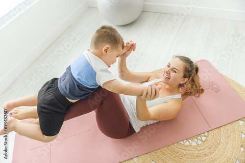 Sport Activities With Baby. Young Black Mom Exercising With Her Infant Son At Home, Happy Woman training with kid at home
