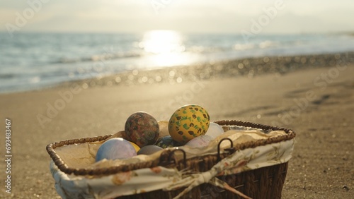 Sunset on the beach by the sea, from the background to the Basket with Easter eggs.