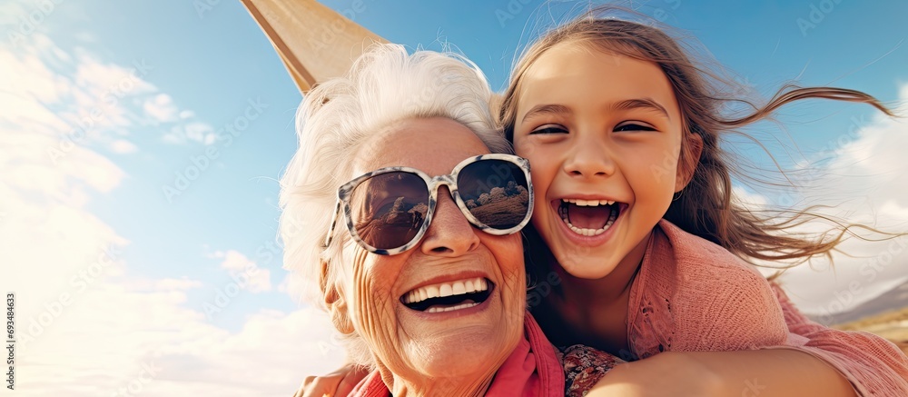 Happy girl and grandmother bonding while taking a selfie on vacation. Happy girl and grandmother bonding while taking a selfie on vacation.