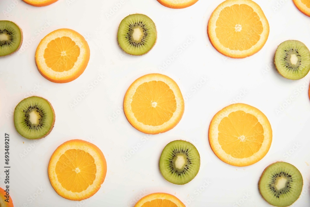Kiwi and orange slices on a white background