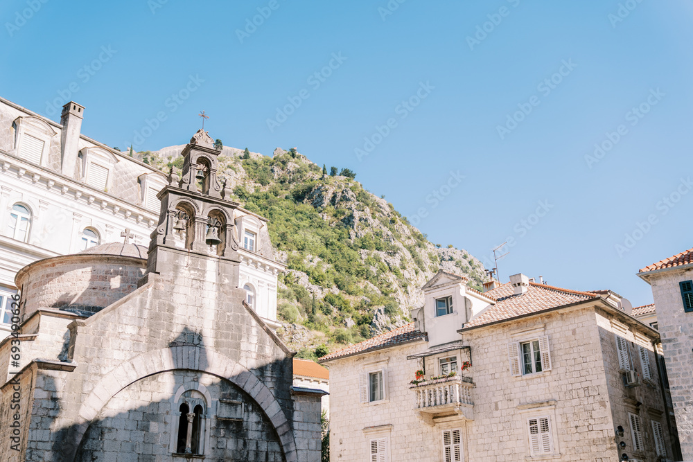 Ancient stone church of St. Luke among the houses at the foot of the mountains. Kotor, Montenegro