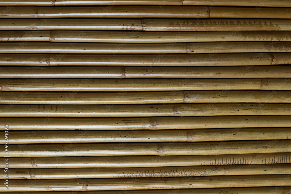 background of lined bamboo trunks in yellow tone with horizontal texture background of lined bamboo trunks in yellow tone with horizontal texture