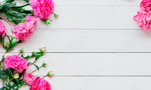 Spring flowers. Pink flowers on white wooden background. Flat lay, top view