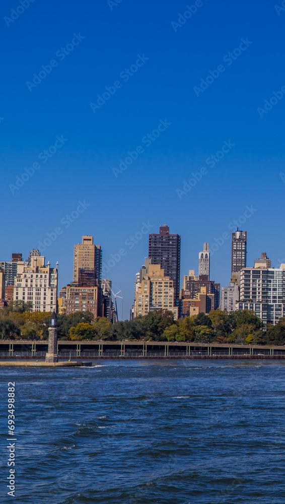 Panoramic view of buildings in central Manhattan New York seen from the East River Panoramic view of buildings in central Manhattan New York seen from the East River