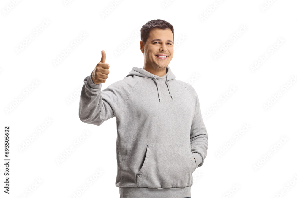 Young man in a gray hoodie showing thumbs up Young man in a gray hoodie showing thumbs up