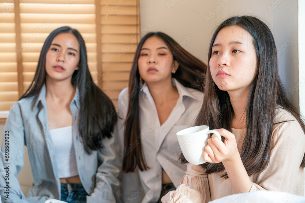 Beautiful asian business women group morning talk together and drink coff on bed Beautiful asian business women group morning talk together and drink coff on bed
