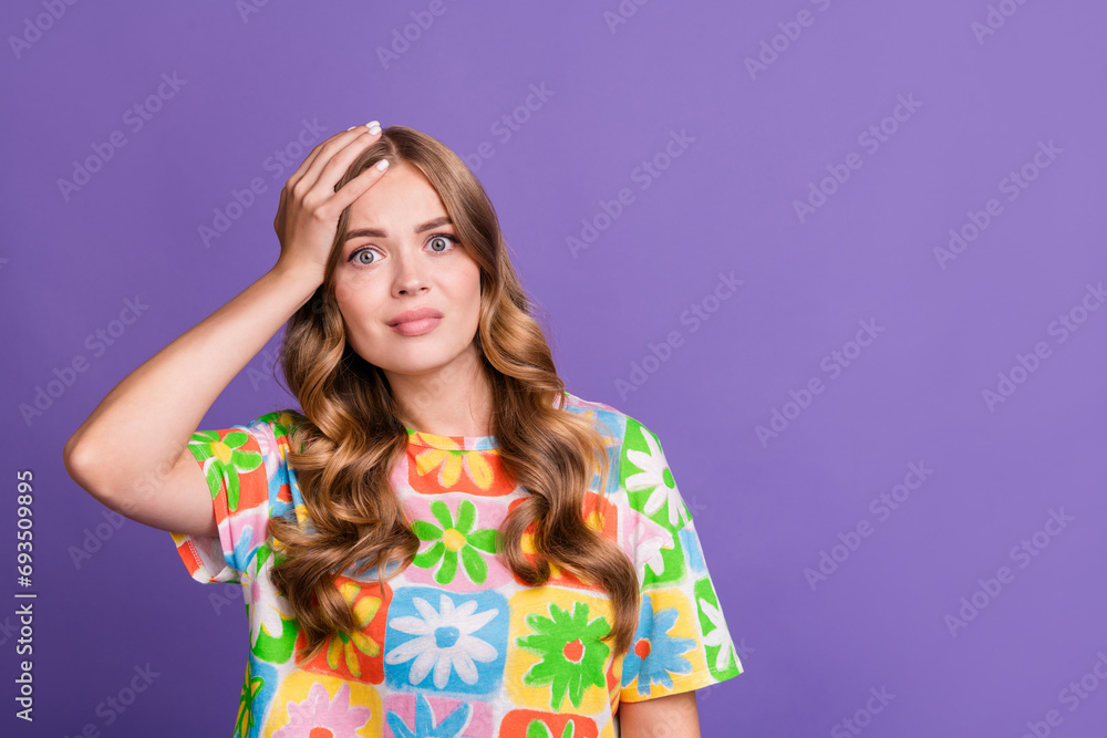 Photo of astonished forgetful woman with wavy hairstyle wear print t-shirt hold palm on forehead isolated on purple color background Photo of astonished forgetful woman with wavy hairstyle wear print t-shirt hold palm on forehead isolated on purple color background