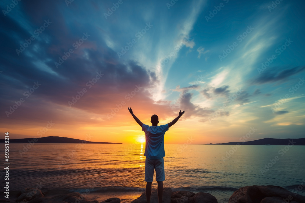 man happy traveler excited raising arms up, back view, blue sky, summer sunset at beach, lifestyle concept, serenity