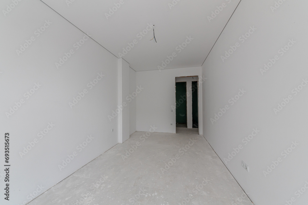 New empty room under construction. Plaster walls. New home. Concrete walls. Interior renovation. New empty room under construction. Plaster walls. New home. Concrete walls. Interior renovation.