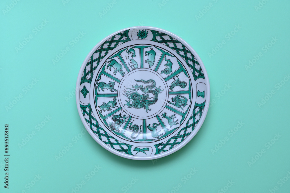 vintage plate with an image of a Chinese dragon on a green background