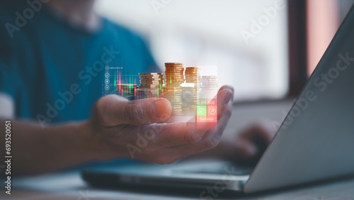 investment and finance concept, businessman holding virtual trading graph and blurred coins on hand, stock market, profits and business growth. photo