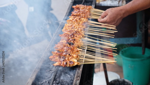 chicken satay on the grill photo