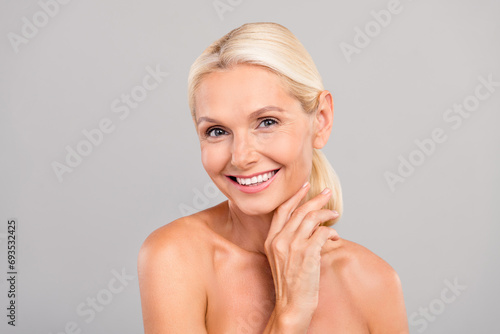 Portrait of positive lovely lady hand touching soft skin enjoy complexion  no wrinkles quality procedure isolated on gray color background
