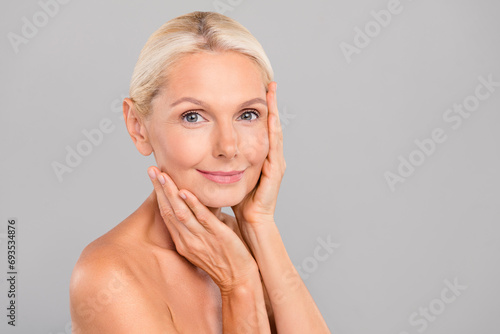 Portrait of charming grandmother lady touch face enjoy soft pure facial skin after daily cream isolated grey color background