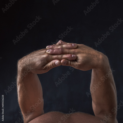 
model man's hands clasped behind his back