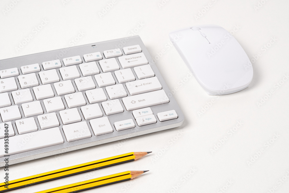 View of keyboard and mouse of a modern computer with pencils. View of keyboard and mouse of a modern computer with pencils.