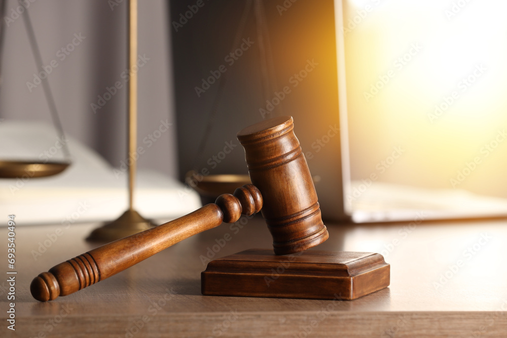 Law. Judge's gavel and scales of justice on wooden table Law. Judge's gavel and scales of justice on wooden table