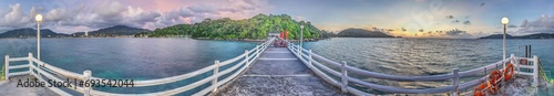 Panoramic picture over a jetty with wooden railing over the tropical sea near Patong on Phuket photo