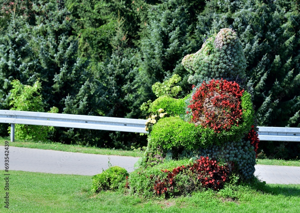 A sculpture made of a squirrel using ornamental flowers