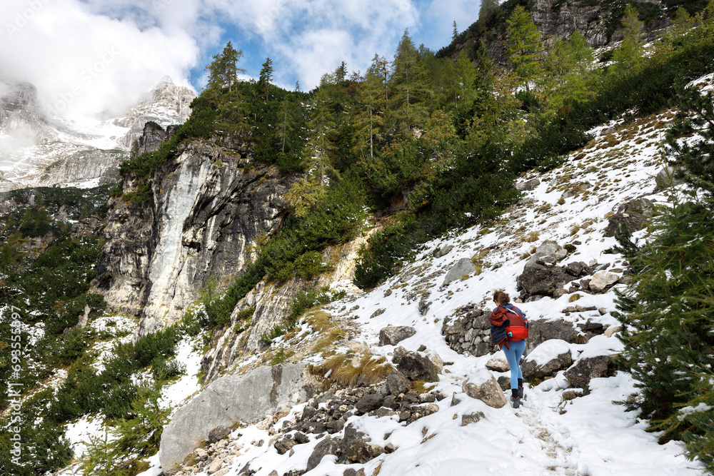 Hiker Effort Hiking Uphill on Snow Covered Mountain Path in European Alps Environment in Autumn Hiker Effort Hiking Uphill on Snow Covered Mountain Path in European Alps Environment in Autumn