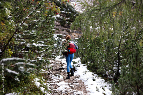 Ascending on a Mountain Trail Path for a Solo Adventurous Woman in Off Season Snowy Landscape © Fotopogledi