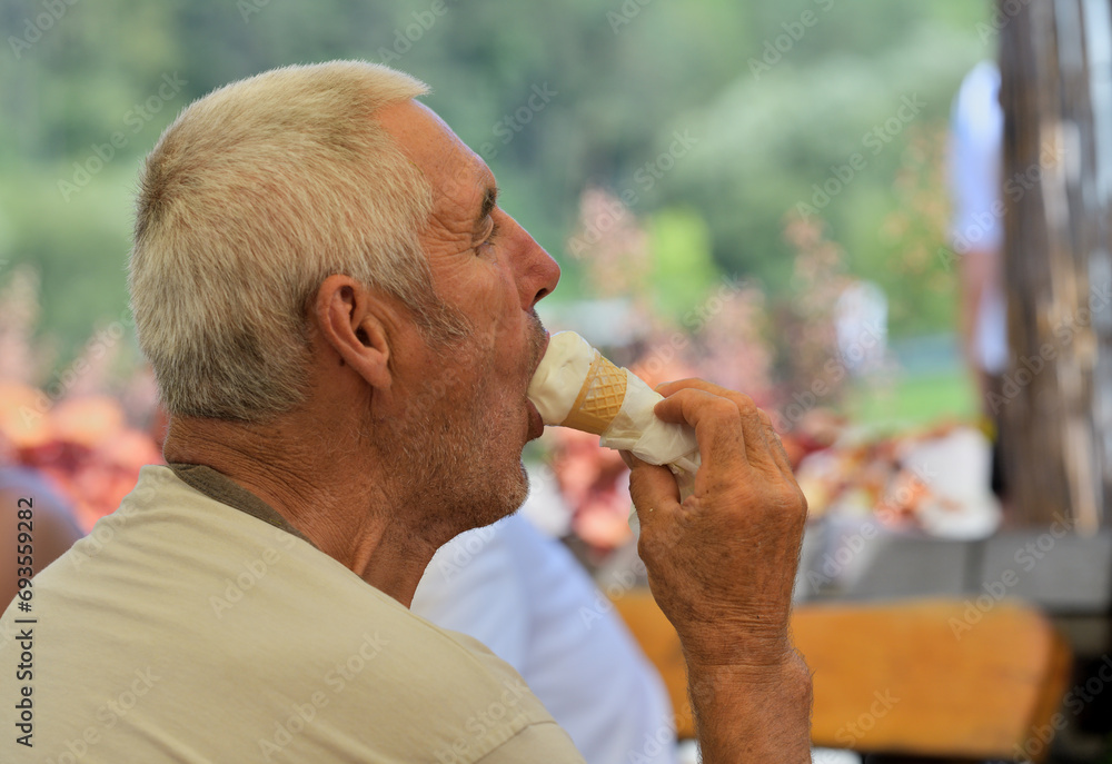 People lick sweet ice cream on a trip in hot summer