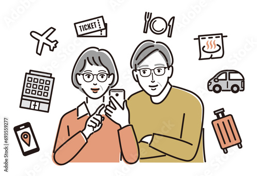 スマホで旅行の予約をする高齢の男女