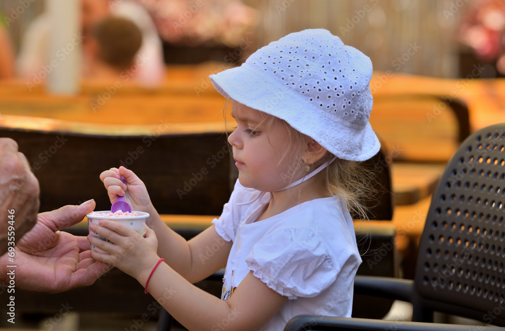 Portrait of a girl enjoying sweet ice cream in hot summer