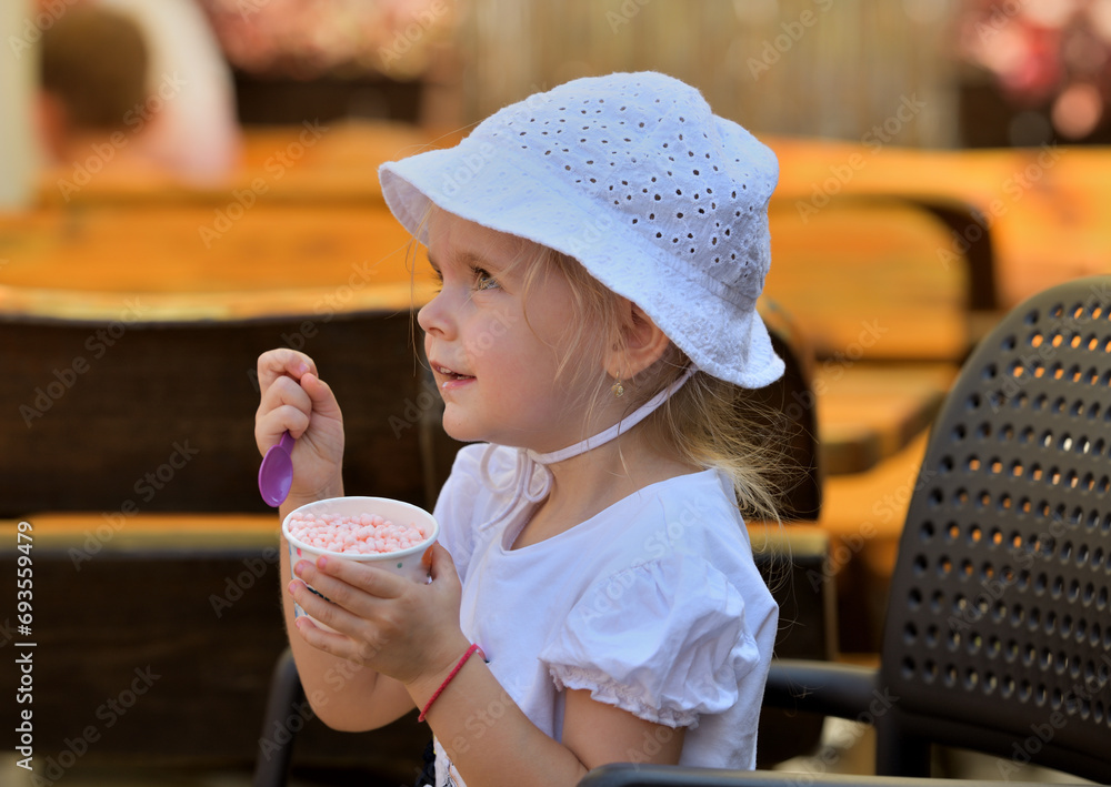 Portrait of a girl enjoying sweet ice cream in hot summer