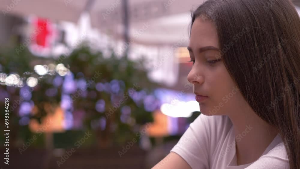 Young girl feeling sad with Christmas lights in the background Young girl feeling sad with Christmas lights in the background