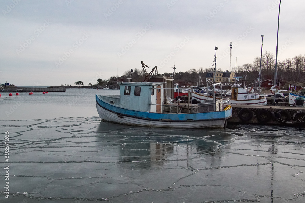 a boat is docked at the harbour during winter