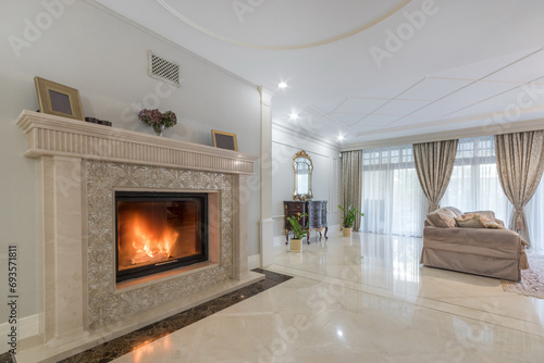 The interior of the living room in neoclassical style in a luxurious mansion. Fireplace .with exclusive decor. photo