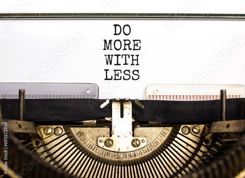 Do more with less symbol. Concept word Do more with less typed on beautiful old retro typewriter. Beautiful white paper background. Business do more with less concept. Copy space. photo