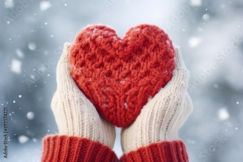 Knitted heart in hands. Background with selective focus and copy space