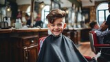 Cute little boy at the barber shop getting his haircut 