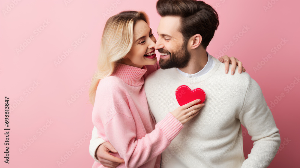 happy couple closely embracing and smiling against a pink background. happy couple closely embracing and smiling against a pink background.